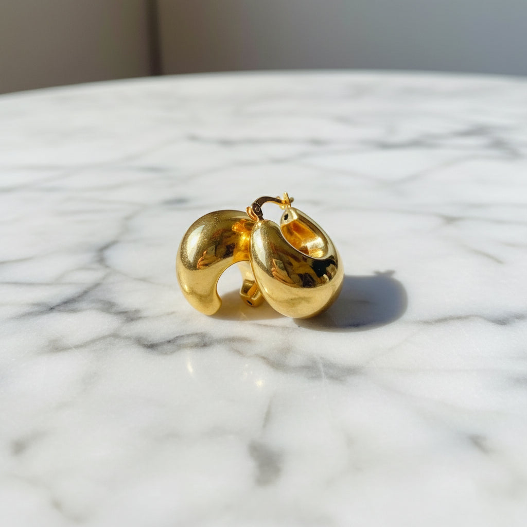 Gold hoop earrings on a white surface with a blue background gold silver bubble dome hoop earrings for women ladies queens exclusive craftsmanship gold 925 silver sterling silver gold-plated jewellery jewelry Deep Shine Jewellers DSJ Your Time To Shine affordable luxury beauty trendy shop now 