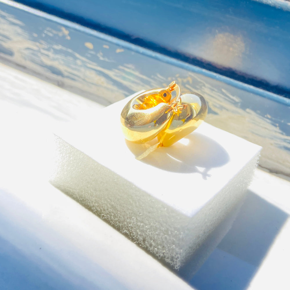 Gold ring on a white stand with a blurred outdoor background gold silver bubble dome hoop earrings for women ladies queens exclusive craftsmanship gold 925 silver sterling silver gold-plated jewellery jewelry Deep Shine Jewellers DSJ Your Time To Shine affordable luxury beauty trendy shop now 