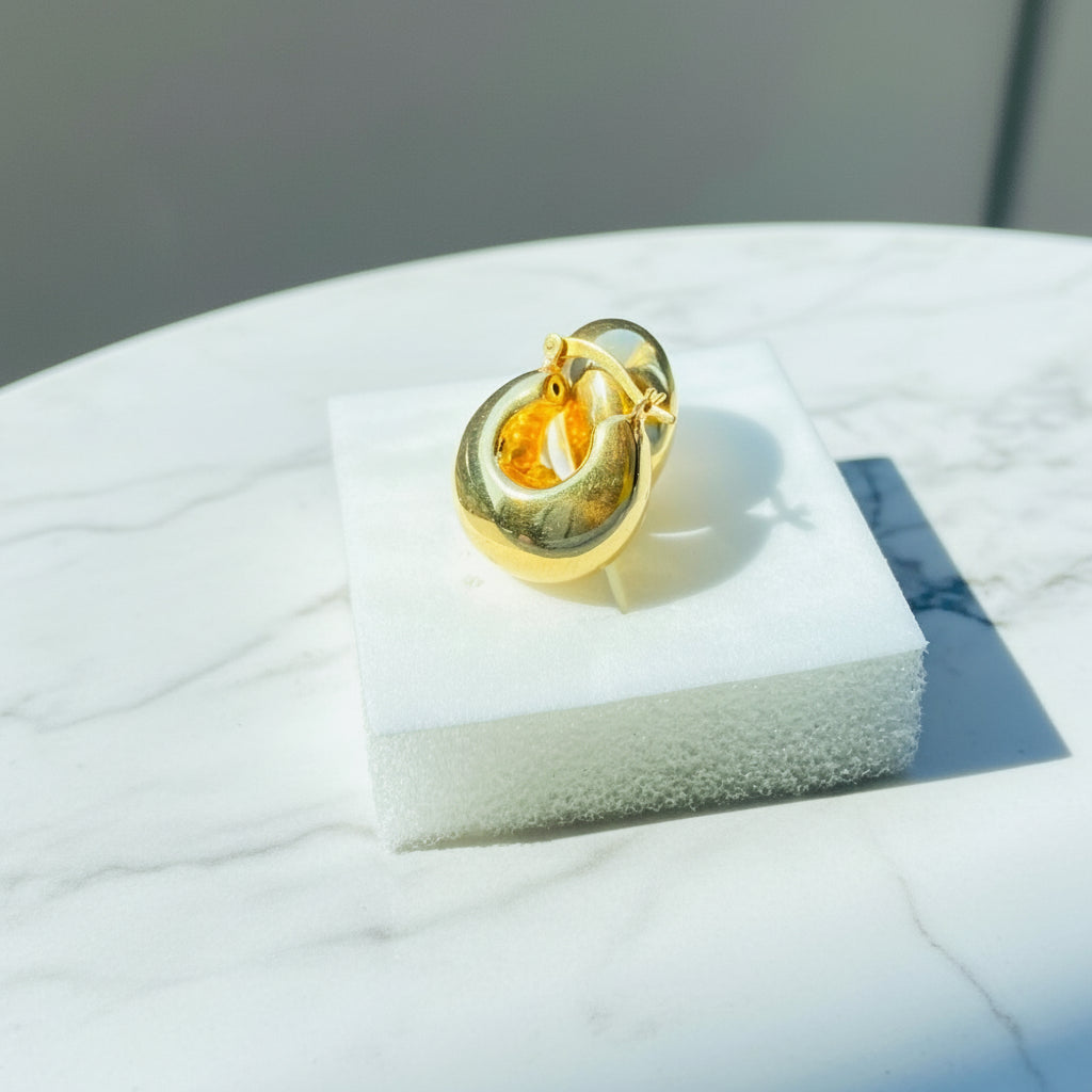 Gold ring on a white stand with a blurred background gold silver bubble dome hoop earrings for women ladies queens exclusive craftsmanship gold 925 silver sterling silver gold-plated jewellery jewelry Deep Shine Jewellers DSJ Your Time To Shine affordable luxury beauty trendy shop now 