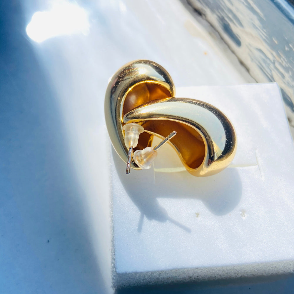 Gold and white earring on a white cushion with a blue background Gold Drop Form Earrings stainless steel female womens queens jewellery jewelry Deep Shine Jewellers Your Time To Shine DSJ affordable luxury exclusive craftsmanship