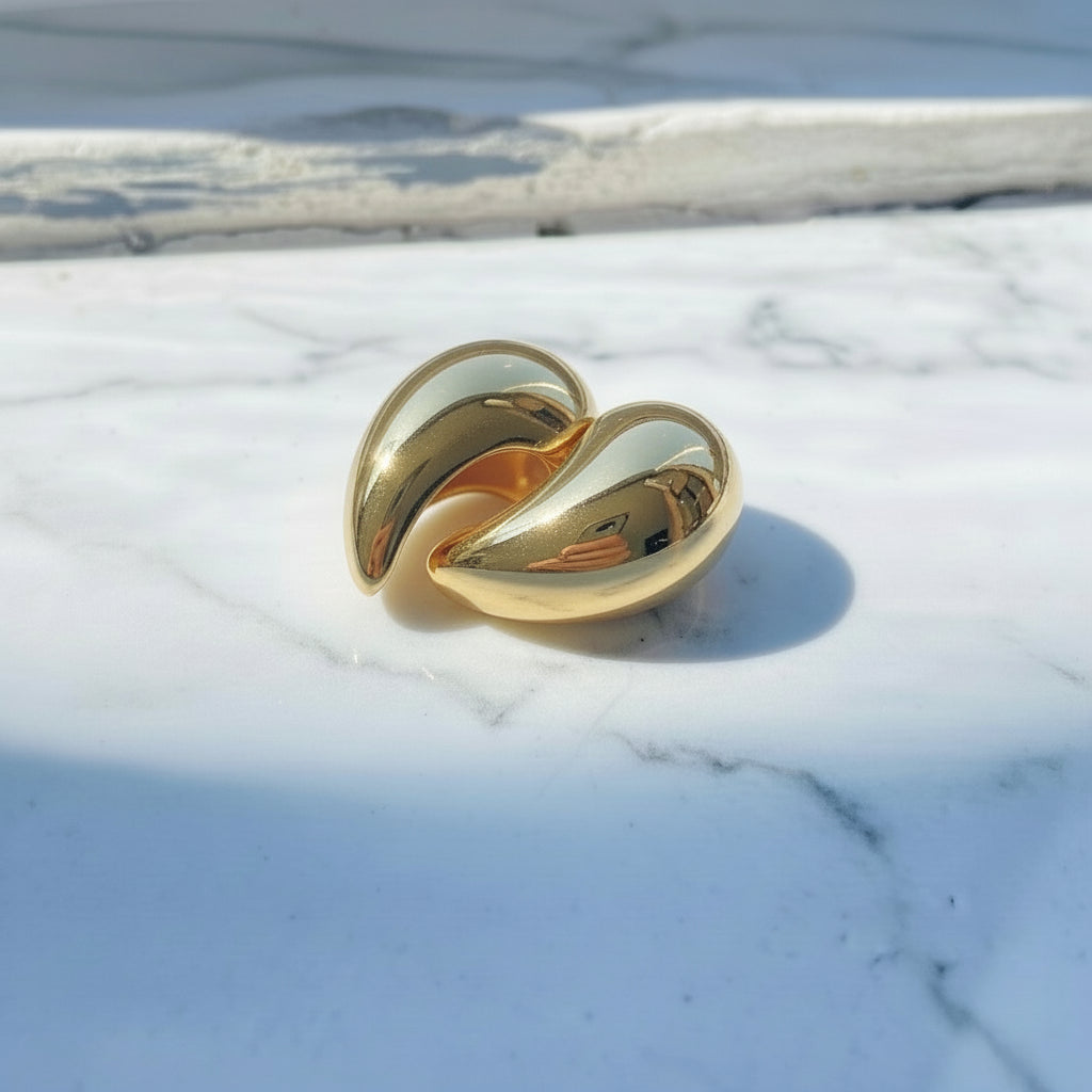 Gold ring on a reflective surface Gold Drop Form Earrings stainless steel female womens queens jewellery jewelry Deep Shine Jewellers Your Time To Shine DSJ affordable luxury exclusive craftsmanship