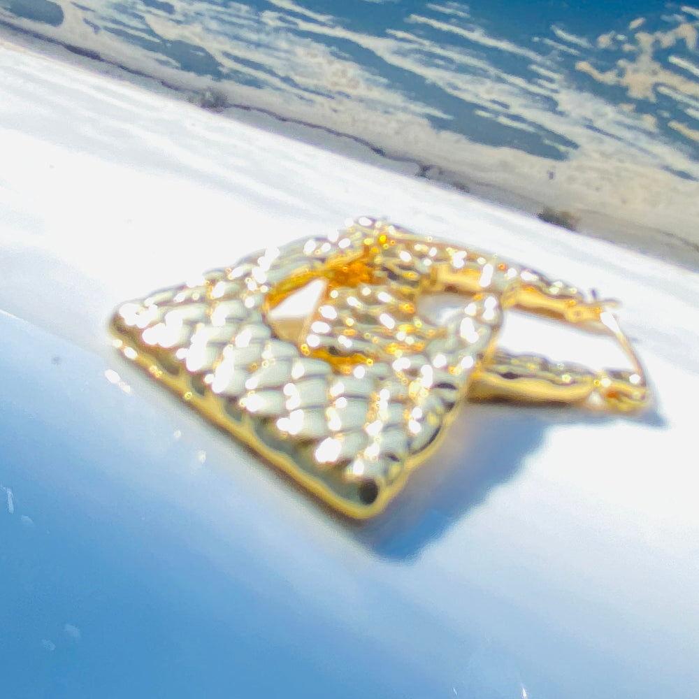 Decorative brooch with gold and pearl details on a blue background  Gold crown-shaped object on a white stand with a blurred outdoor background gold crocodile design earrings stainless steel exclusive Deep Shine Jewellers DSJ jewellery jewelry Your Time To Shine queens womens ladies kingdome 