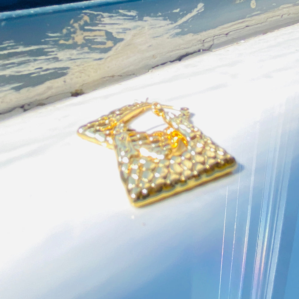 Decorative gold brooch with gemstones on a metallic surface Gold crown-shaped object on a white stand with a blurred outdoor background gold crocodile design earrings stainless steel exclusive Deep Shine Jewellers DSJ jewellery jewelry Your Time To Shine queens womens ladies kingdom