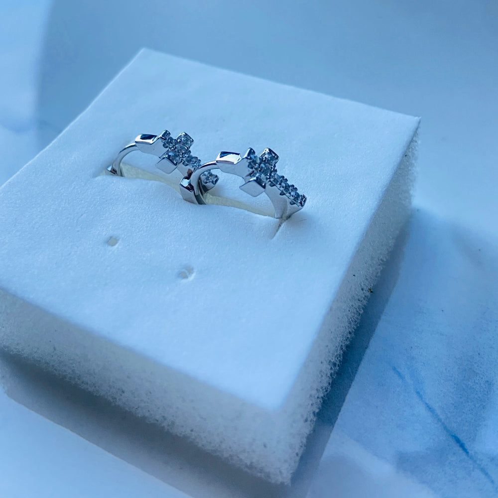 Silver ring with small diamonds on a white cushion in a blue box