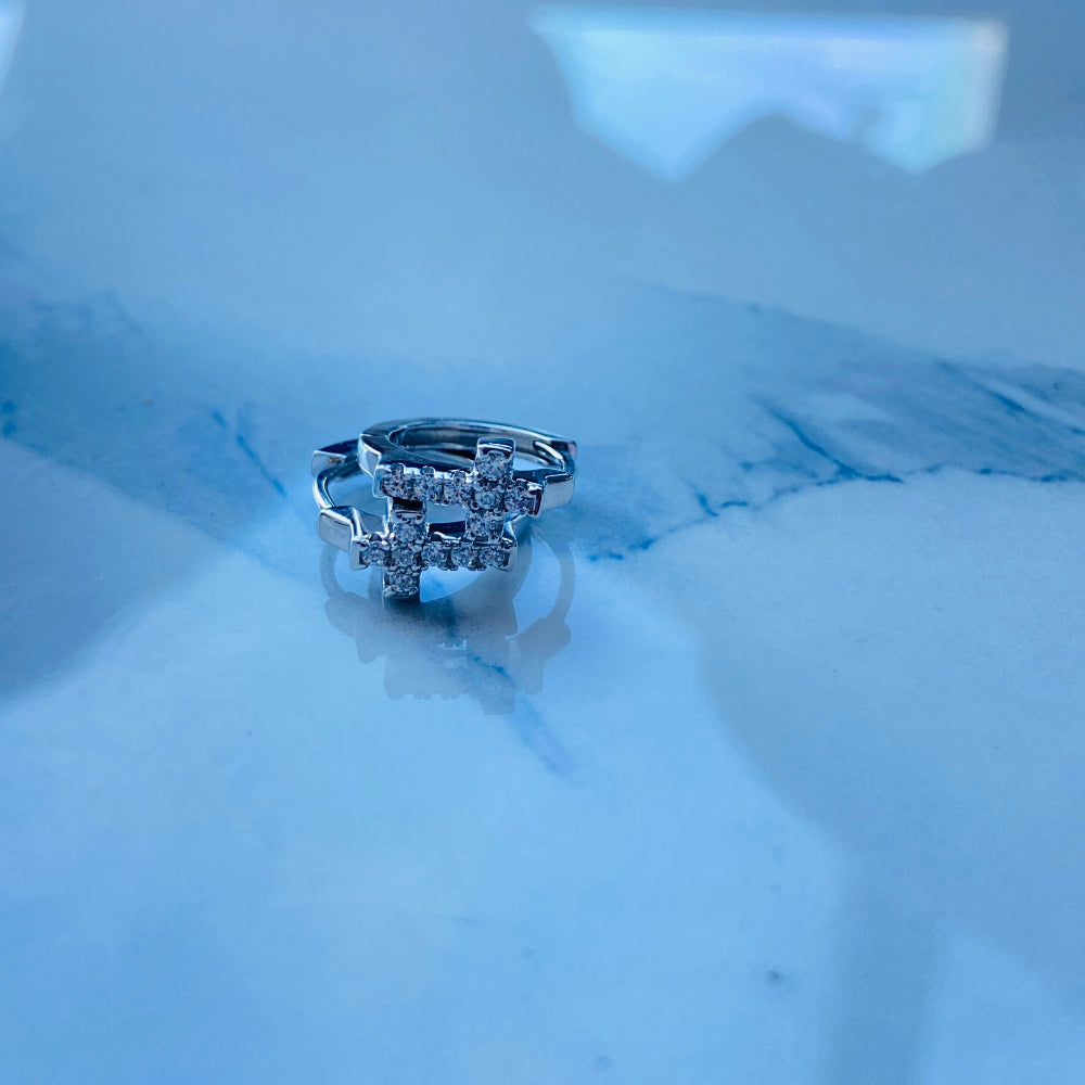 Silver ring with diamonds on a white marble surface. white gold/silver crossed ice earrings cubic zirconia diamonds sleeper hoop Deep Shine Jewellers Jewellers jewelry DSJ. exclusive affordable jewellery Your Time To Shine 925 silver sterling silver 