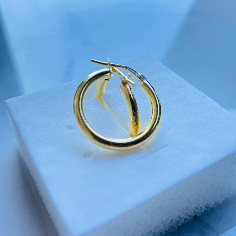 Gold hoop earring on a white stand with a blue background Gold silver sleepers for mens women kings queens man lady kingdom exclusive by Deep Shine Jewellers jewellery jewelry affordable luxury shinning DSJ Your Time To Shine Cape town craftsmanship 