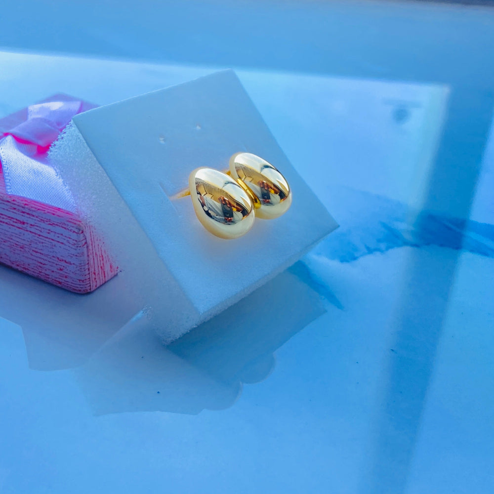 Gold earrings on a white card with a scenic background gold silver rain drop earrings for women ladies queens 925 silver sterling silver exclusive jewellery crafted jewelry kingdom of DSJ Deep Shine Jewellers Your Time To Shine gold plated shinning 