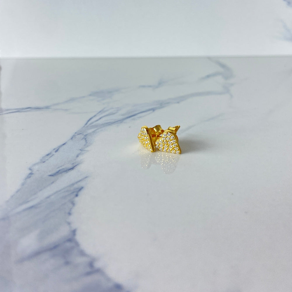 Gold crown-shaped earring on a marble surface Heart-shaped gold earrings on a marble surface gold ice heart stud earrings gold plated golden 925 silver sterling silver exclusive craftsmanship premium jewellery jewelry affordable luxury best sellers trending christmas sale Deep Shine Jewellery DSJ Your Time To Shine online store diamond gemstones lab diamond cubic zirconia