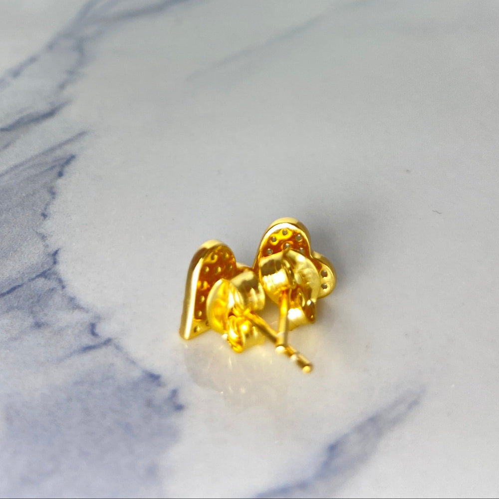 Gold earring on a marble surface Heart-shaped gold earrings on a marble surface gold ice heart stud earrings gold plated golden 925 silver sterling silver exclusive craftsmanship premium jewellery jewelry affordable luxury best sellers trending christmas sale Deep Shine Jewellery DSJ Your Time To Shine online store diamond gemstones lab diamond cubic zirconia