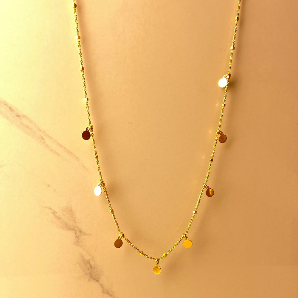 Gold necklace with small beads on a marble surface Gold necklace with round pendants on a blue marble surface Radiant Gold Circle and Block Link Necklace by Deep Shine Jewellers gold plated golden 925 silver sterling silver women ladies queens elegant exclusive craftsmanship cape town artisans affordable luxury premium jewellery jewelry chains best sellers trending online store shop now Your Time To Shine DSJ 