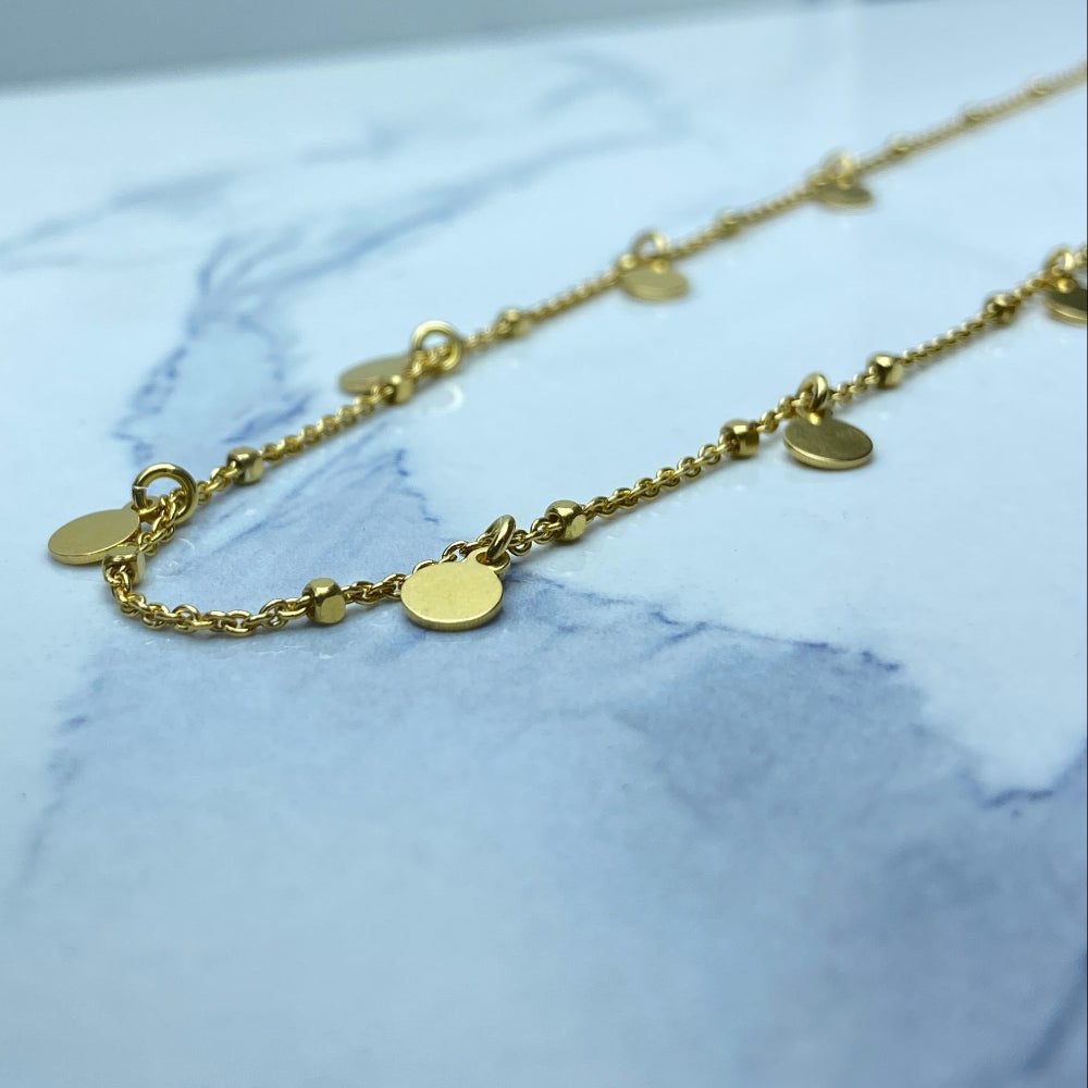 Gold bracelet on a marble surface Gold necklace with round pendants on a blue marble surface Radiant Gold Circle and Block Link Necklace by Deep Shine Jewellers gold plated golden 925 silver sterling silver women ladies queens elegant exclusive craftsmanship cape town artisans affordable luxury premium jewellery jewelry chains best sellers trending online store shop now Your Time To Shine DSJ 