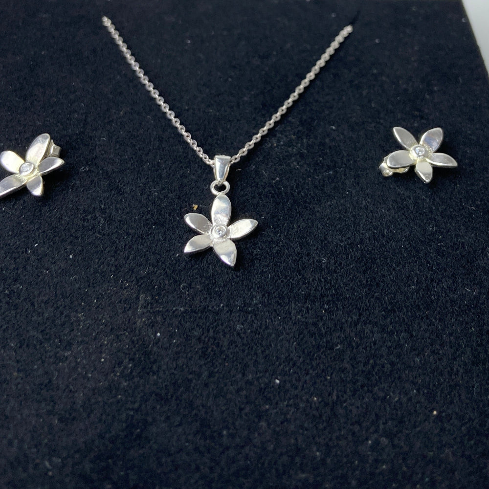 Silver butterfly necklace and earrings on a black display box with a white background Silver flower-shaped earrings on a marble surface with a blurred background silver flower stud earrings diamond lab diamond cubic zirconia gemstone women ladies queens exclusive craftsmanship cape town affordable luxury premium jewellery jewelry Deep Shine Jewellers DSJ Your Time To Shine best sellers trending 925 silver sterling silver shop now christmas sale 