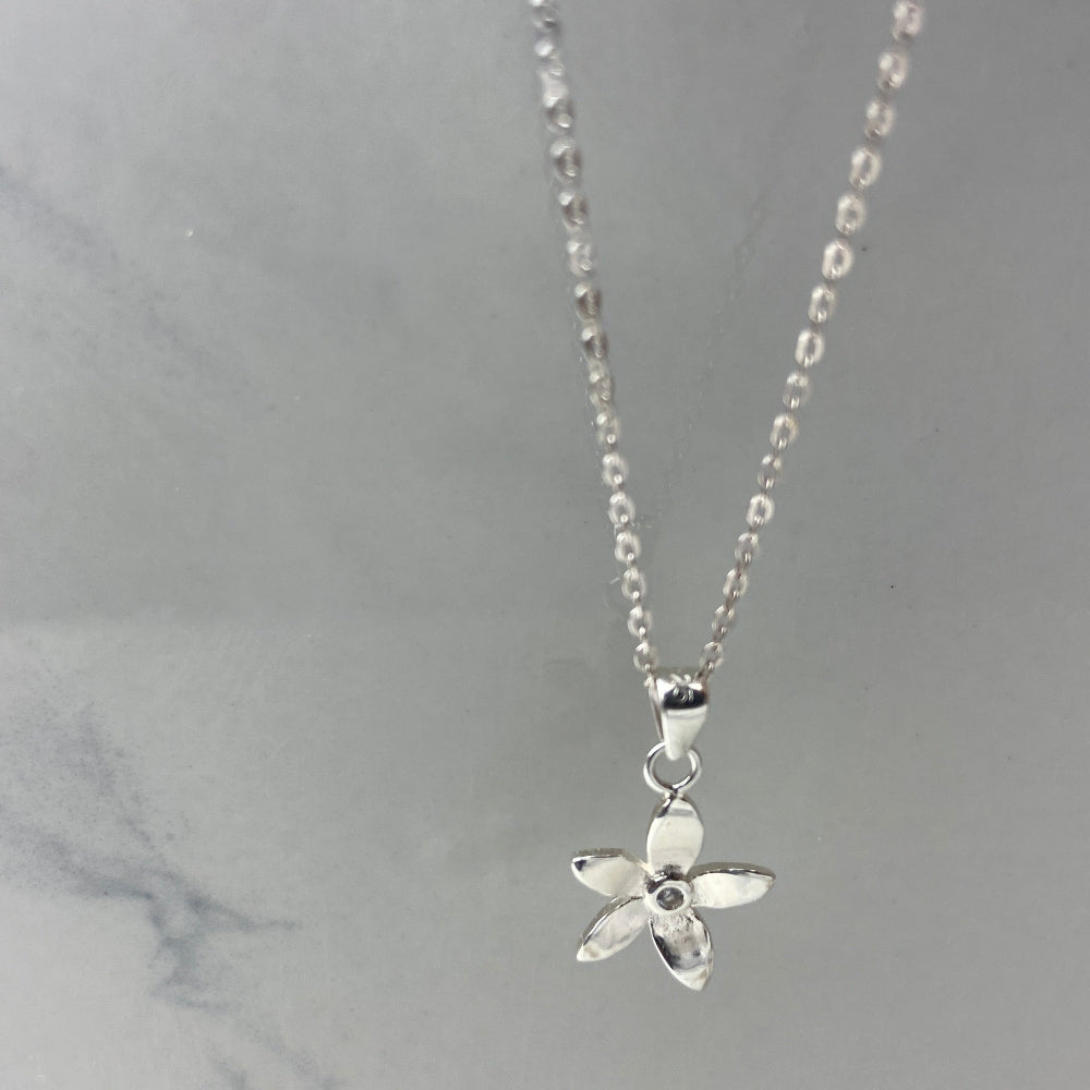 Silver starfish pendant necklace on a marble surface Silver flower-shaped earrings on a marble surface with a blurred background silver flower stud earrings diamond lab diamond cubic zirconia gemstone women ladies queens exclusive craftsmanship cape town affordable luxury premium jewellery jewelry Deep Shine Jewellers DSJ Your Time To Shine best sellers trending 925 silver sterling silver shop now christmas sale 