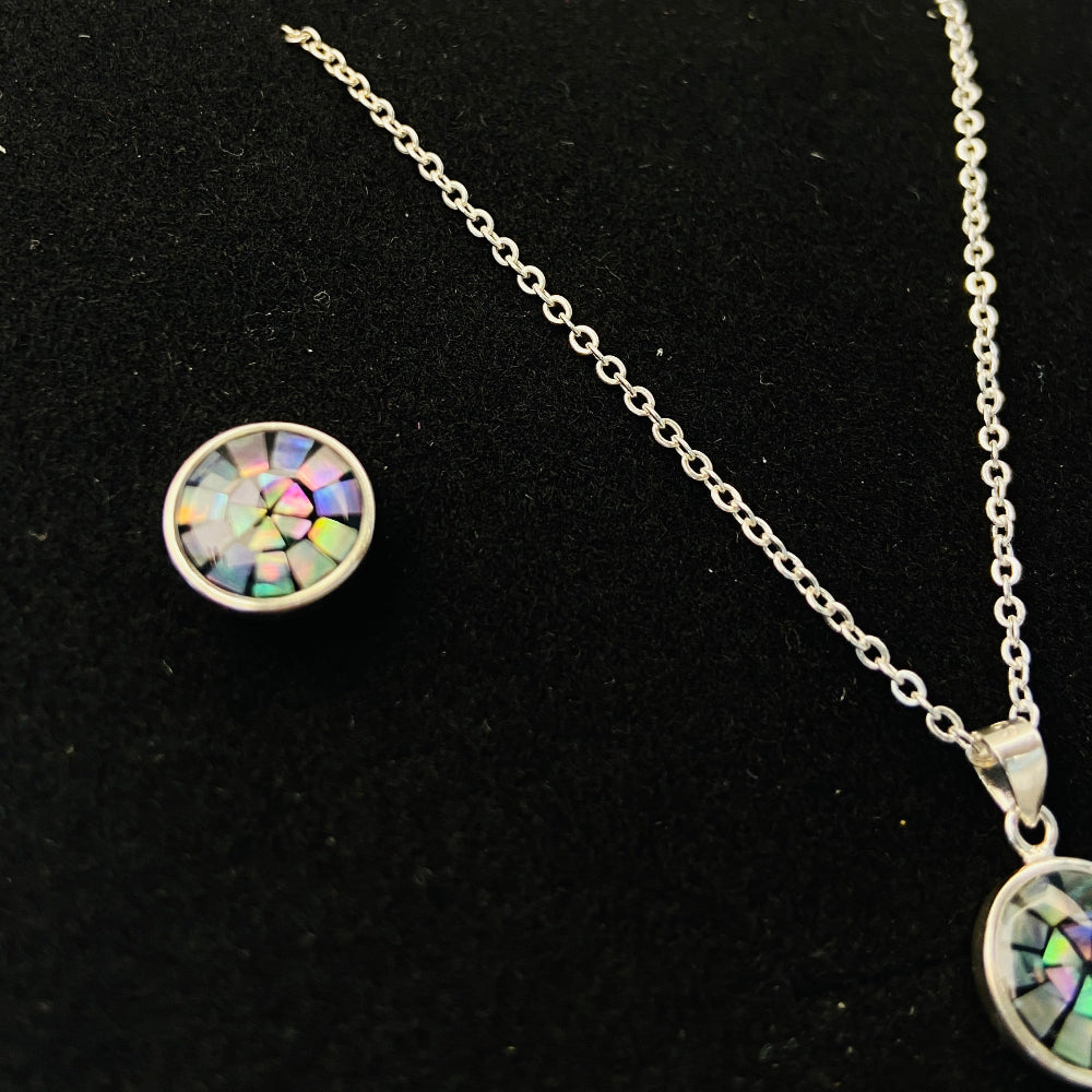 Two necklaces with round pendants on a marble surface silver paua necklace and earrings set chain women ladies queens 925 silver sterling silver exclusive craftsmanship elegance affordable luxury premium jewellery jewelry cape town artisans high quality best sellers trending Deep Shine Jewellers DSJ Your Time To Shine shop now kingdom Christmas sale 