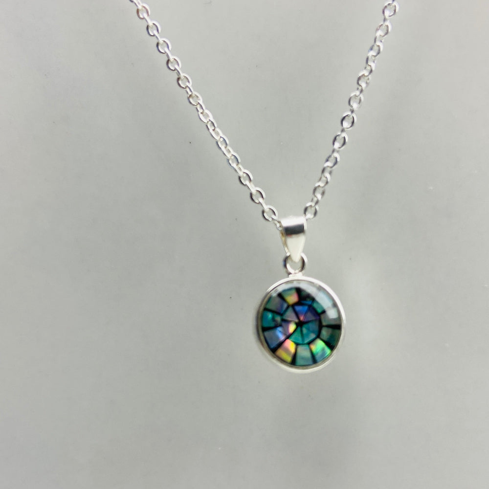 Silver necklace with a round pendant on a light gray background Two necklaces with round pendants on a marble surface silver paua necklace and earrings set chain women ladies queens 925 silver sterling silver exclusive craftsmanship elegance affordable luxury premium jewellery jewelry cape town artisans high quality best sellers trending Deep Shine Jewellers DSJ Your Time To Shine shop now kingdom Christmas sale 