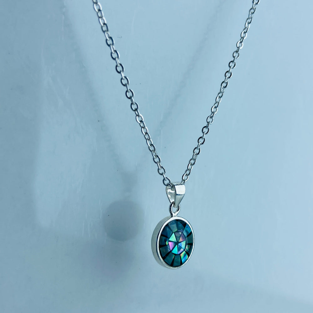 Necklace with a blue gemstone pendant on a light gray background Two necklaces with round pendants on a marble surface silver paua necklace and earrings set chain women ladies queens 925 silver sterling silver exclusive craftsmanship elegance affordable luxury premium jewellery jewelry cape town artisans high quality best sellers trending Deep Shine Jewellers DSJ Your Time To Shine shop now kingdom Christmas sale 