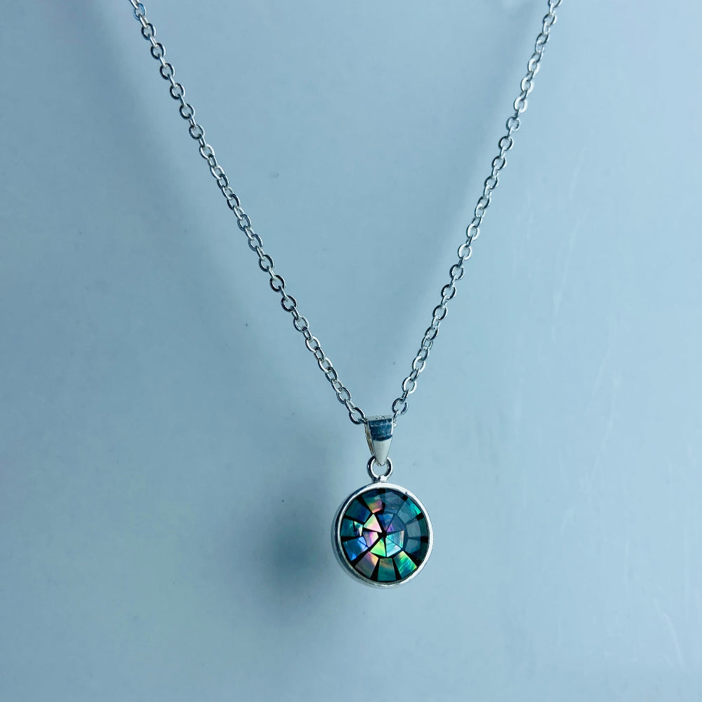 Necklace with a round pendant on a light blue background Two necklaces with round pendants on a marble surface silver paua necklace and earrings set chain women ladies queens 925 silver sterling silver exclusive craftsmanship elegance affordable luxury premium jewellery jewelry cape town artisans high quality best sellers trending Deep Shine Jewellers DSJ Your Time To Shine shop now kingdom Christmas sale 