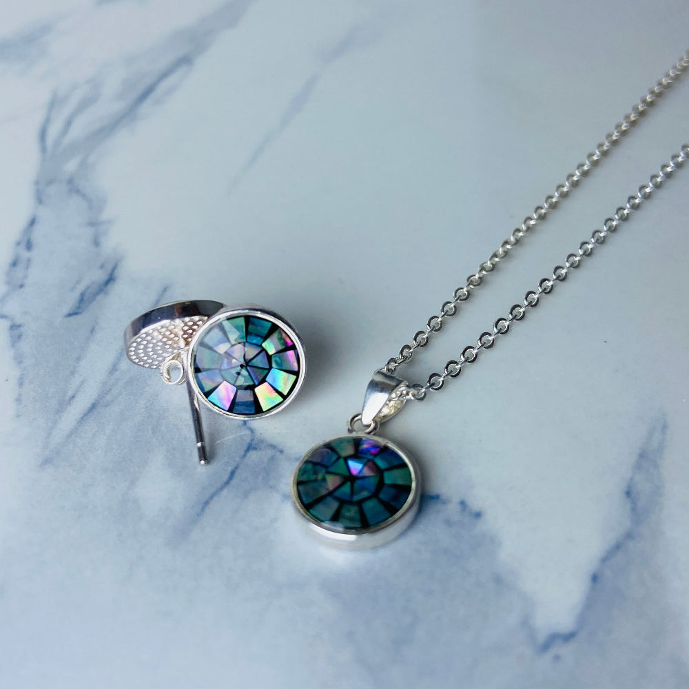 Two necklaces with round pendants on a marble surface silver paua necklace and earrings set chain women ladies queens 925 silver sterling silver exclusive craftsmanship elegance affordable luxury premium jewellery jewelry cape town artisans high quality best sellers trending Deep Shine Jewellers DSJ Your Time To Shine shop now kingdom Christmas sale 