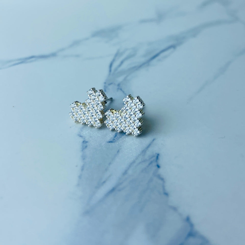 Silver butterfly-shaped earrings on a marble surface Radiant Silver Pixelated Heart Necklace and Earrings Set by Deep Shine Jewellery women ladies queens 925 silver sterling silver cubic zirconia gemstone diamond lab diamond exclusive craftsmanship cape town artisans affordable luxury best seller trending christmas sale gift wishlish Your Time To Shine DSJ online store shop now 