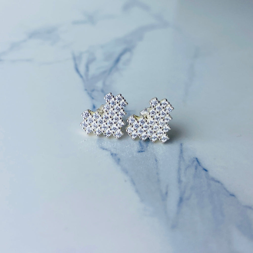 Silver butterfly-shaped earrings on a marble surface Radiant Silver Pixelated Heart Necklace and Earrings Set by Deep Shine Jewellery women ladies queens 925 silver sterling silver cubic zirconia gemstone diamond lab diamond exclusive craftsmanship cape town artisans affordable luxury best seller trending christmas sale gift wishlish Your Time To Shine DSJ online store shop now 