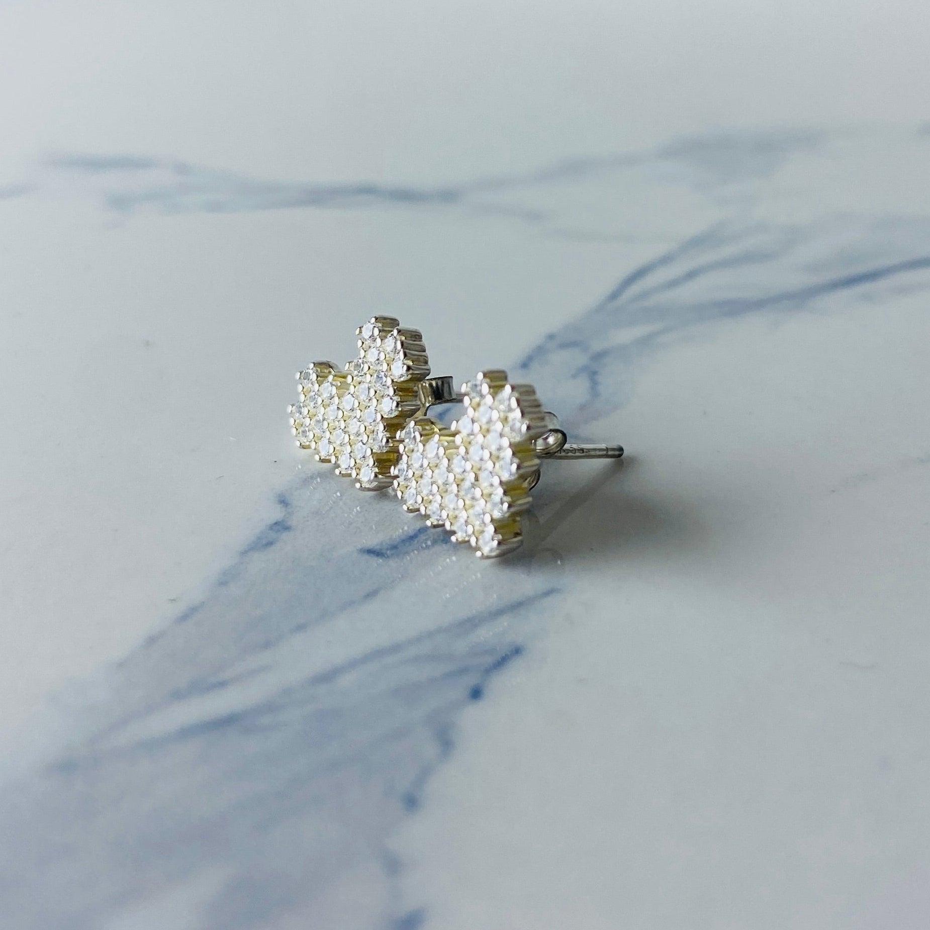 Pair of pearl earrings on a marble surface Silver butterfly-shaped earrings on a marble surface Radiant Silver Pixelated Heart Necklace and Earrings Set by Deep Shine Jewellery women ladies queens 925 silver sterling silver cubic zirconia gemstone diamond lab diamond exclusive craftsmanship cape town artisans affordable luxury best seller trending christmas sale gift wishlish Your Time To Shine DSJ online store shop now 