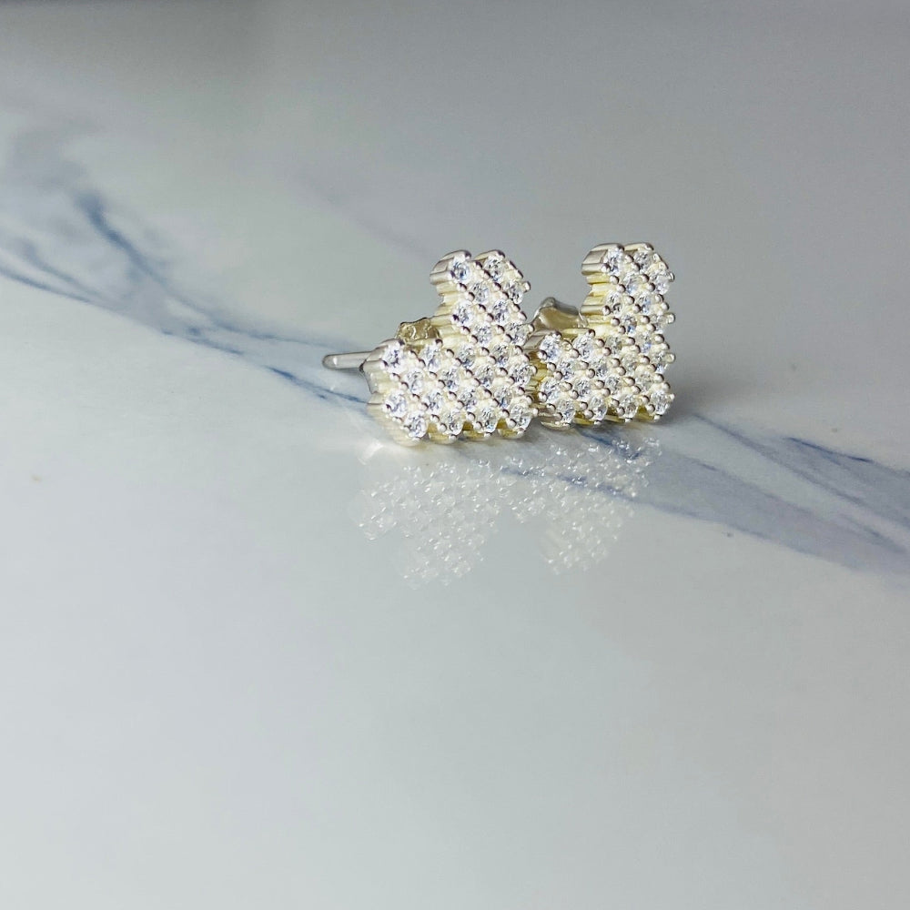 Pair of pearl stud earrings on a marble surface Silver butterfly-shaped earrings on a marble surface Radiant Silver Pixelated Heart Necklace and Earrings Set by Deep Shine Jewellery women ladies queens 925 silver sterling silver cubic zirconia gemstone diamond lab diamond exclusive craftsmanship cape town artisans affordable luxury best seller trending christmas sale gift wishlish Your Time To Shine DSJ online store shop now 