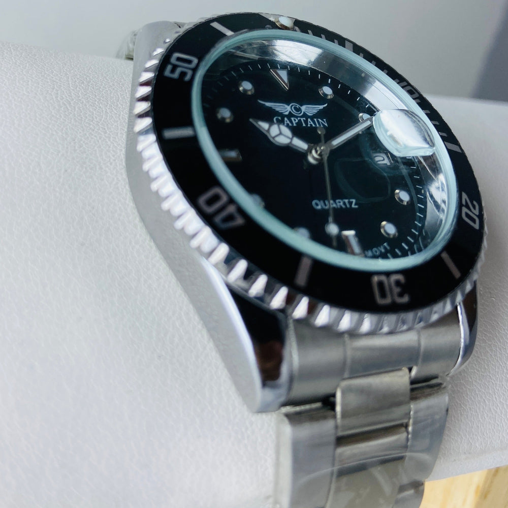 Silver watch with a black face on a white background Silver watch with black dial on a white surface captain mens watch black dial stainless steel rotating bezel quartz movement swiss movement timepiece watches timeless elegance brand new polished watched sapphire crystal hour markings jewellery jewelry premium quality affordable luxury best sellers trending shop now Deep Shine Jewellers DSJ Your Time To Shine mens gents kings 