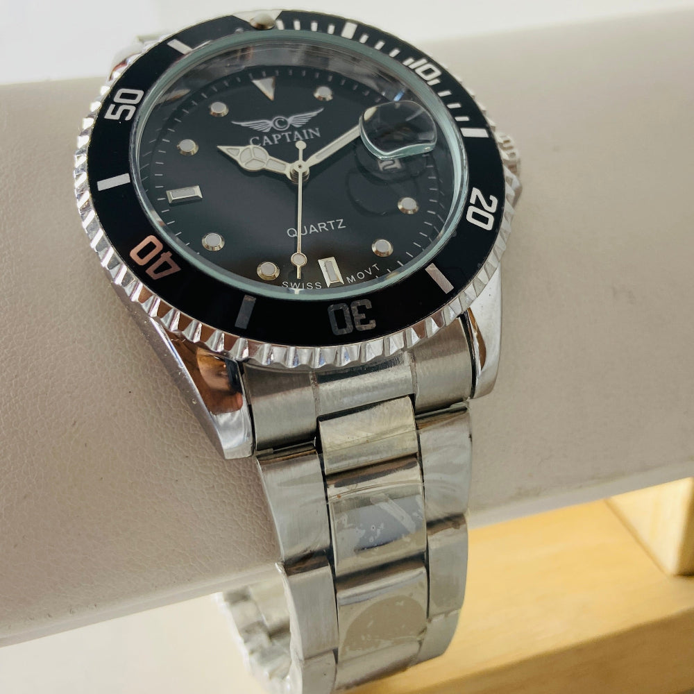 Silver watch with a black face on a white surface Silver watch with black dial on a white surface captain mens watch black dial stainless steel rotating bezel quartz movement swiss movement timepiece watches timeless elegance brand new polished watched sapphire crystal hour markings jewellery jewelry premium quality affordable luxury best sellers trending shop now Deep Shine Jewellers DSJ Your Time To Shine mens gents kings 