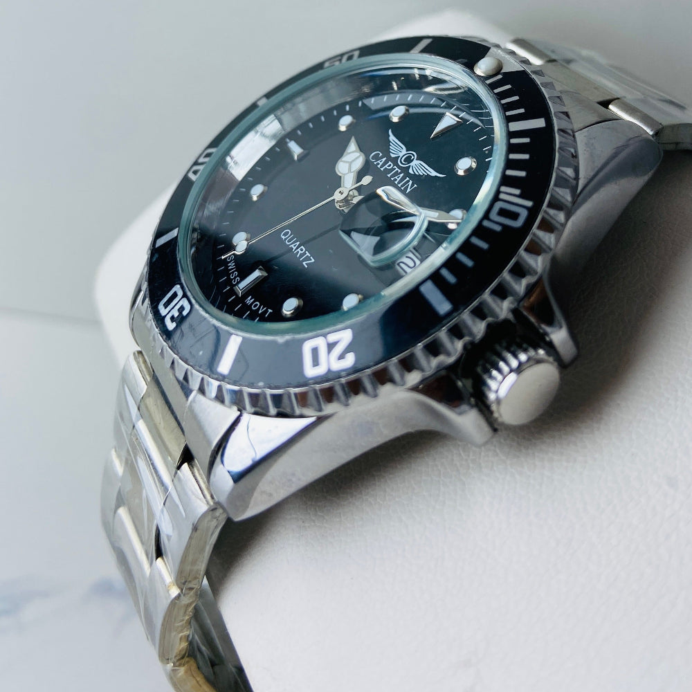 Silver watch with a black face on a light gray background Silver watch with black dial on a white surface captain mens watch black dial stainless steel rotating bezel quartz movement swiss movement timepiece watches timeless elegance brand new polished watched sapphire crystal hour markings jewellery jewelry premium quality affordable luxury best sellers trending shop now Deep Shine Jewellers DSJ Your Time To Shine mens gents kings 