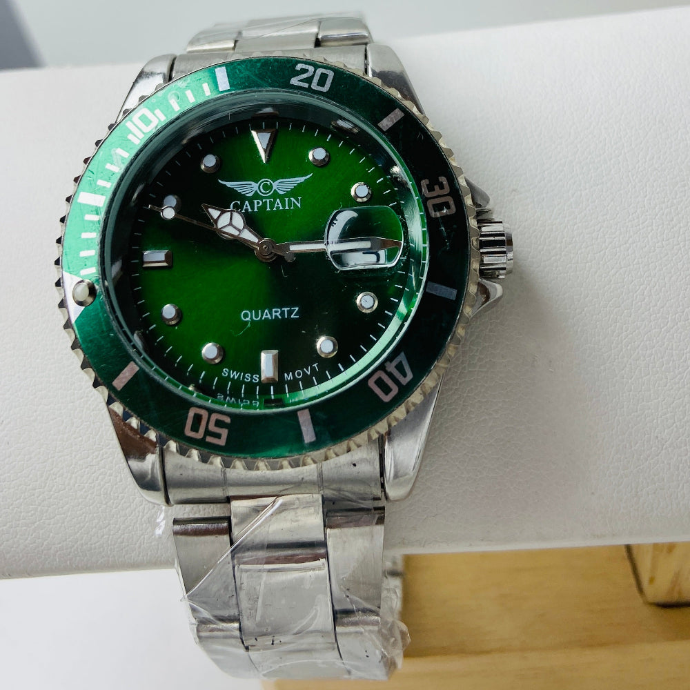 Wristwatch with green dial and silver metal strap on a white surface Silver watch with black dial on a white surface captain mens watch black dial stainless steel rotating bezel quartz movement swiss movement timepiece watches timeless elegance brand new polished watched sapphire crystal hour markings jewellery jewelry premium quality affordable luxury best sellers trending shop now Deep Shine Jewellers DSJ Your Time To Shine mens gents kings 