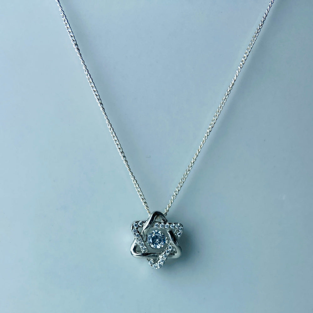 Silver necklace with a star-shaped pendant on a light blue background Silver necklace with a floral pendant on a marble surface white gold silver dancing diamond pendant necklace chain diamond cubic zirconia gemstone lab diamond exclusive craftsmanship affordable luxury premium jewellery jewelry ladies women queens Deep Shine Jewellers DSJ Your Time To Shine best seller trending 925 silver sterling silver 