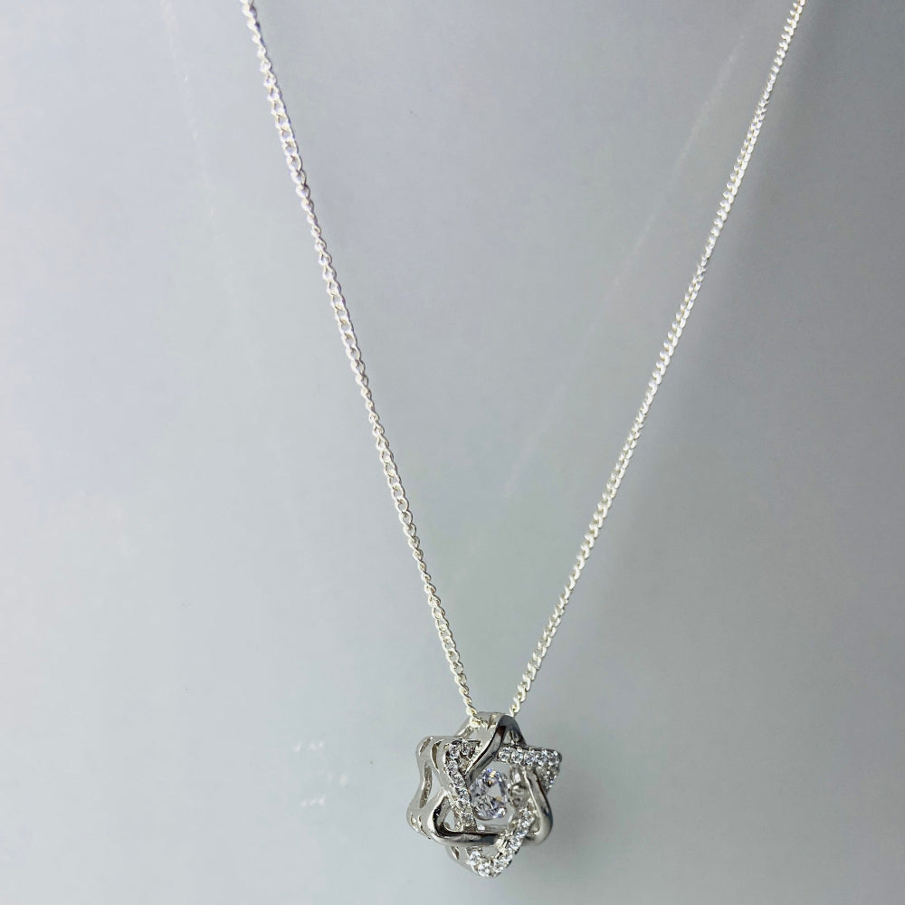 Silver necklace with a heart-shaped pendant on a light gray background Silver necklace with a floral pendant on a marble surface white gold silver dancing diamond pendant necklace chain diamond cubic zirconia gemstone lab diamond exclusive craftsmanship affordable luxury premium jewellery jewelry ladies women queens Deep Shine Jewellers DSJ Your Time To Shine best seller trending 925 silver sterling silver 