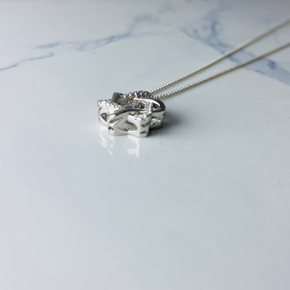 Silver necklace with a heart-shaped pendant on a marble surface Silver necklace with a floral pendant on a marble surface white gold silver dancing diamond pendant necklace chain diamond cubic zirconia gemstone lab diamond exclusive craftsmanship affordable luxury premium jewellery jewelry ladies women queens Deep Shine Jewellers DSJ Your Time To Shine best seller trending 925 silver sterling silver 