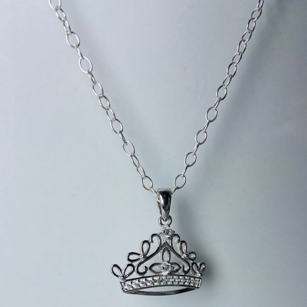Silver crown pendant necklace on a light gray background Silver necklace with a detailed pendant on a marble background Silver necklace silver crown pendant necklace chain exclusive craftsmanship affordable luxury premium jewellery jewelry ladies women queens Deep Shine Jewellers DSJ Your Time To Shine best seller trending 925 silver sterling silver diamond lab diamond gemstones cubic zirconia Christmas special sale festive season holidays gift loved ones cable chain