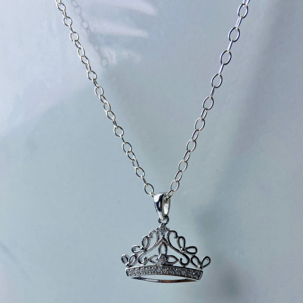Silver crown pendant necklace on a light gray background Silver necklace with a detailed pendant on a marble background Silver necklace silver crown pendant necklace chain exclusive craftsmanship affordable luxury premium jewellery jewelry ladies women queens Deep Shine Jewellers DSJ Your Time To Shine best seller trending 925 silver sterling silver diamond lab diamond gemstones cubic zirconia Christmas special sale festive season holidays gift loved ones cable chain