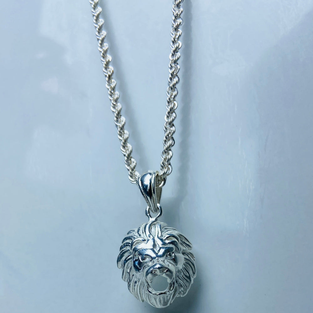 Silver lion head pendant necklace on a marble background Silver lion head pendant on a chain against a marble background Silver Lions head pendant necklace marble surface pendant necklace curb chain exclusive craftsmanship affordable luxury premium jewellery jewelry ladies women queens kings mens gents Deep Shine Jewellers DSJ Your Time To Shine best seller trending 925 silver sterling silver cape town artisans christmas gifts present festive season holiday gifts for love ones