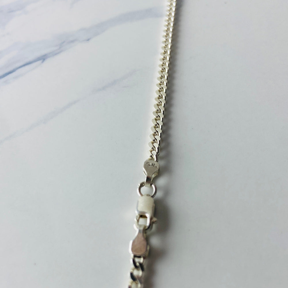 Silver chain necklace with a clear pendant on a light marble background Silver lion head pendant on a chain against a marble background Silver Lions head pendant necklace marble surface pendant necklace curb chain exclusive craftsmanship affordable luxury premium jewellery jewelry ladies women queens kings mens gents Deep Shine Jewellers DSJ Your Time To Shine best seller trending 925 silver sterling silver cape town artisans christmas gifts present festive season holiday gifts for love ones