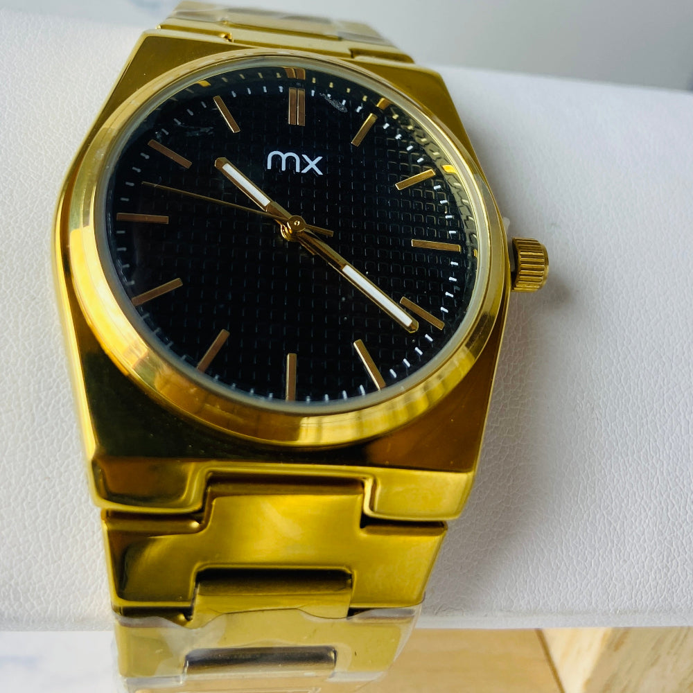Gold watch with black face on a white marble surface gold MX mens watch gold plated stainless steel watches timepiece timeless luxury best seller trending Deep Shine Jewellers DSJ Your Time To Shine quartz movement black dial gold stick markers 36mm gold bezel 