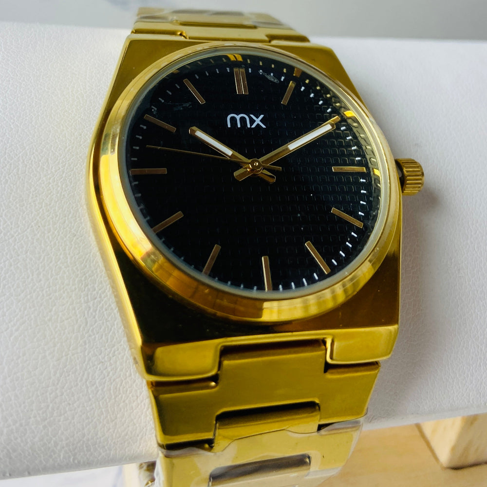Gold watch with black face on a white marble surface gold MX mens watch gold plated stainless steel watches timepiece timeless luxury best seller trending Deep Shine Jewellers DSJ Your Time To Shine quartz movement black dial gold stick markers 36mm gold bezel 
