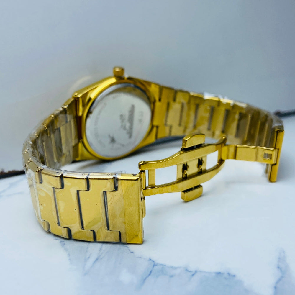 Gold wristwatch on a light blue fabric background Gold watch with black face on a white marble surface gold MX mens watch gold plated stainless steel watches timepiece timeless luxury best seller trending Deep Shine Jewellers DSJ Your Time To Shine quartz movement black dial gold stick markers 36mm gold bezel 