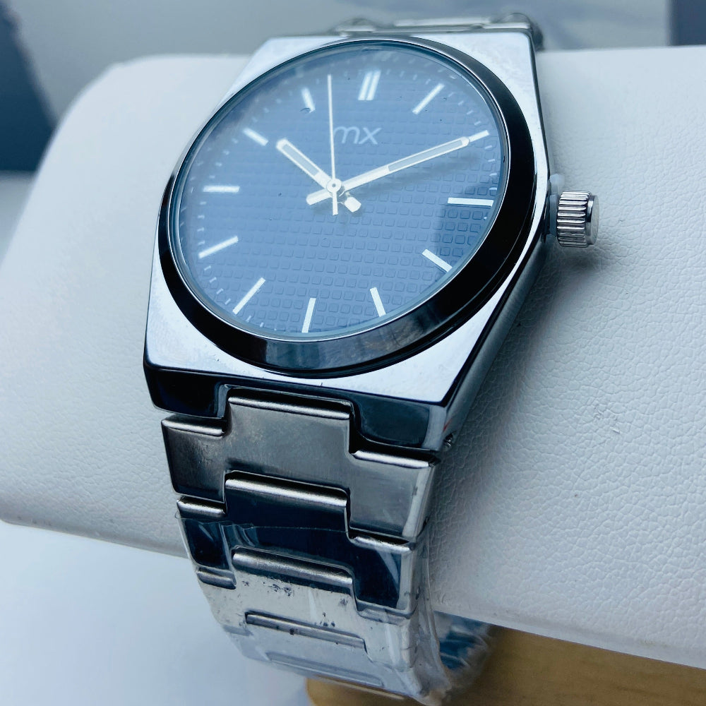 Silver watch with a blue face on a white surface Silver watch with a blue face on a white background silver watch with navy face on a white marble surface silver MX mens watch stainless steel watches timepiece timeless luxury best seller trending Deep Shine Jewellers DSJ Your Time To Shine quartz movement black dial silver stick markers 36mm silver bezel christmas presents gifts holiday season festive season xmas christmas sale Cape town south africa 