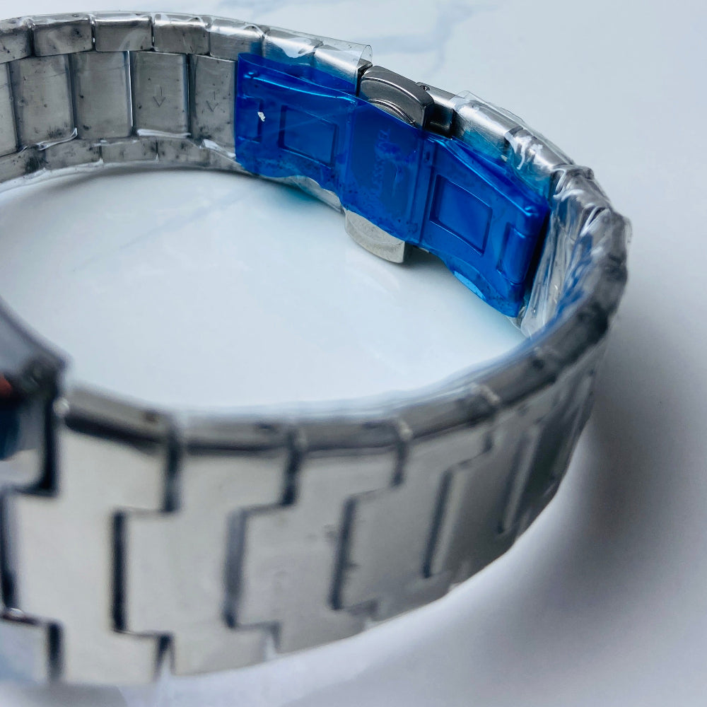 Metallic watch with blue accent on a marble surface Silver watch with a blue face on a white background silver watch with navy face on a white marble surface silver MX mens watch stainless steel watches timepiece timeless luxury best seller trending Deep Shine Jewellers DSJ Your Time To Shine quartz movement black dial silver stick markers 36mm silver bezel christmas presents gifts holiday season festive season xmas christmas sale Cape town south africa 