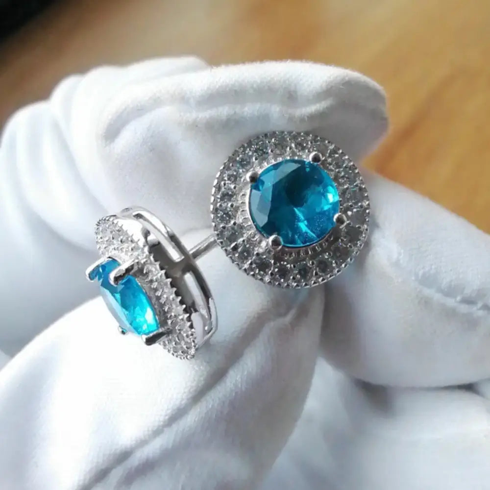 Pair of Aqua Radiance white gold silver earrings with blue gemstone and white accents