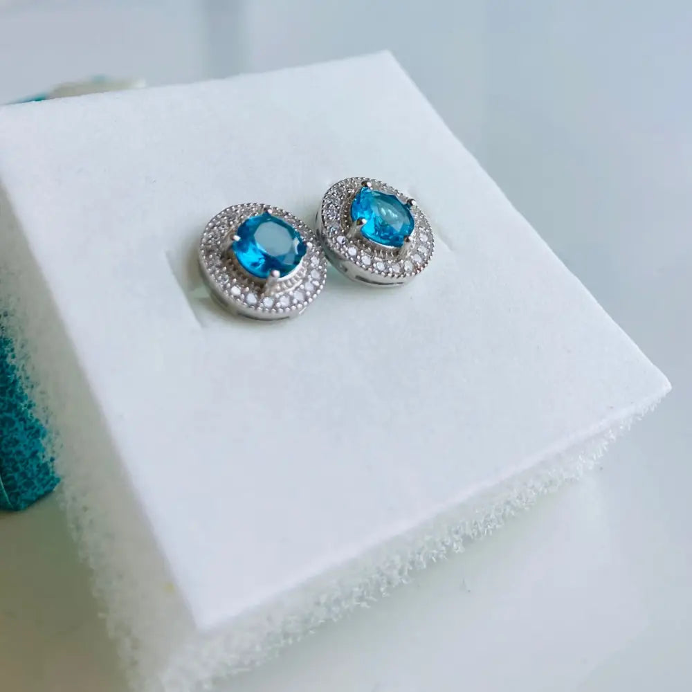 Silver stud earrings with blue gemstones in white gold silver setting for elegant jewelry