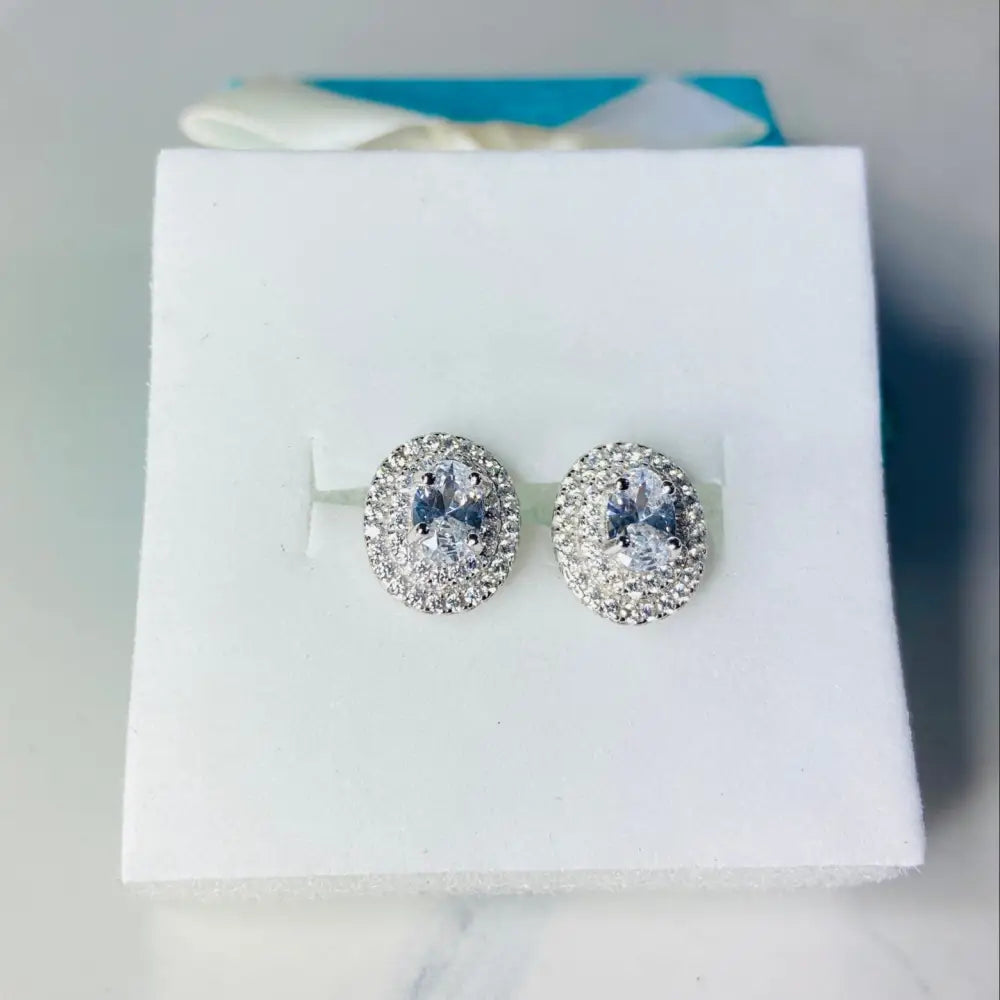 Dazzling oval halo stud earrings in white gold silver with silver flooded shine