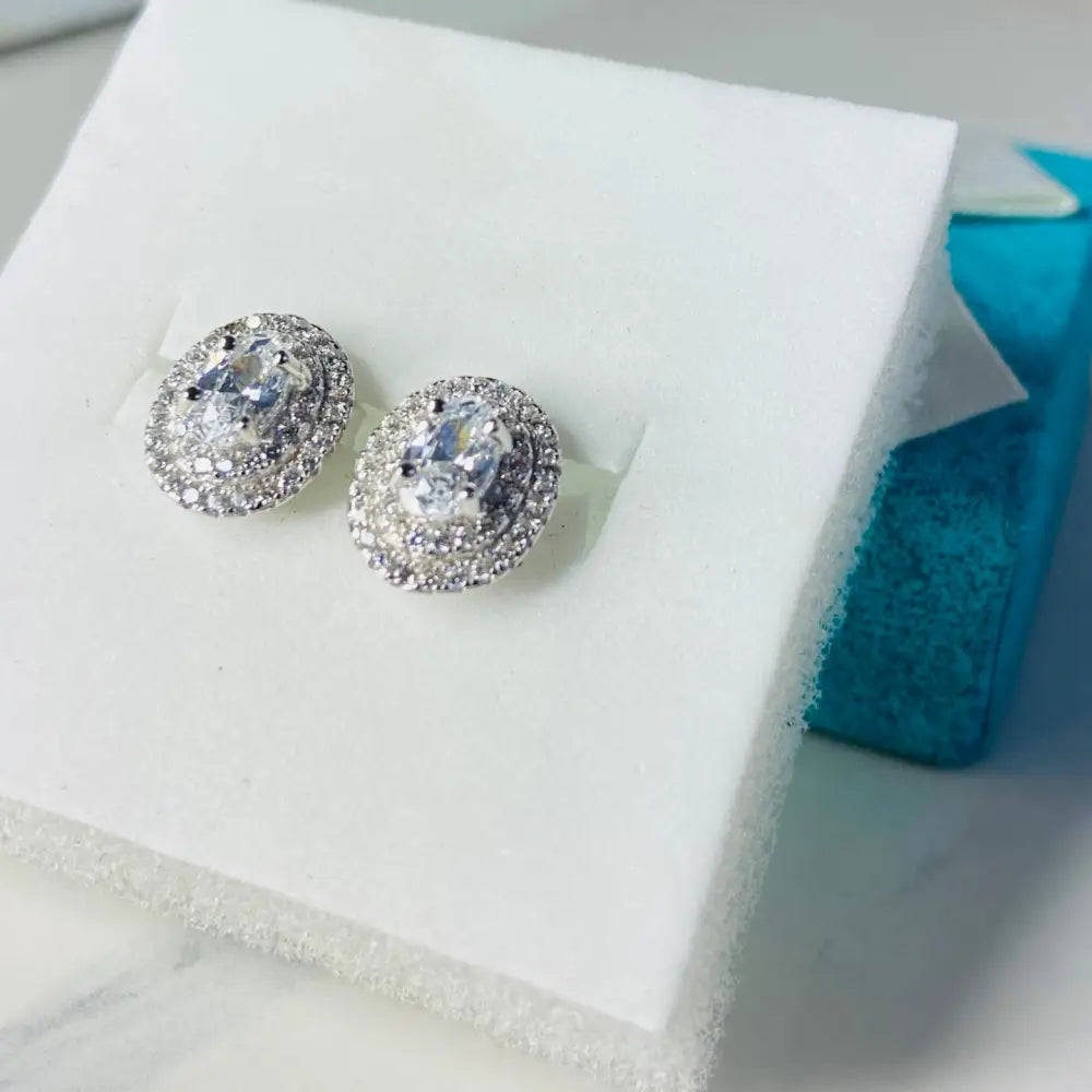 White gold silver flooded oval stud earrings with clear gemstone and pavé-set stones