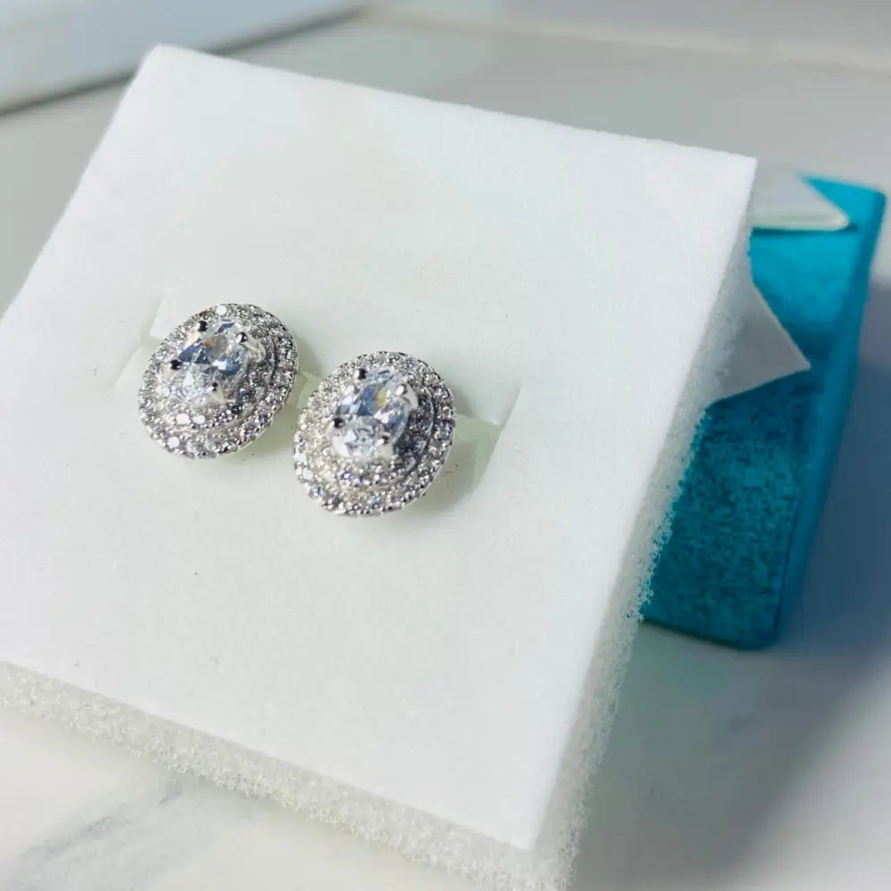 Dazzling oval halo stud earrings in white gold silver with silver flooded shine