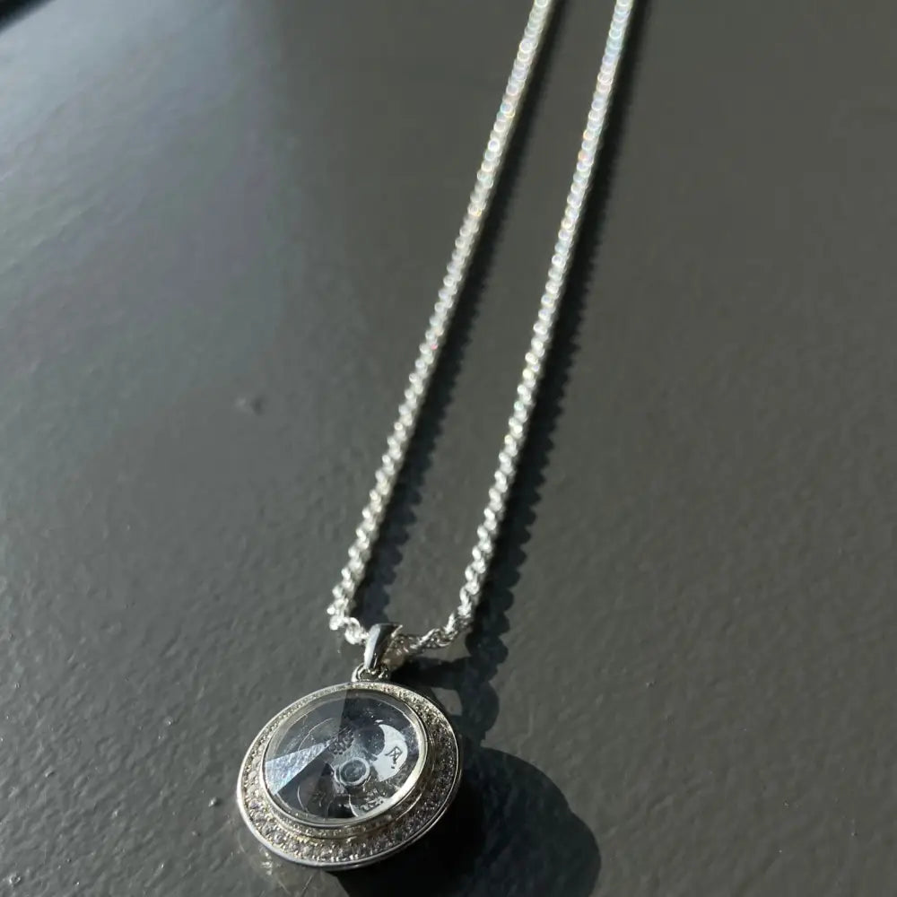 Silver flooded spinning necklace with decorative oval pendant, ideal for white gold silver jewelry enthusiasts