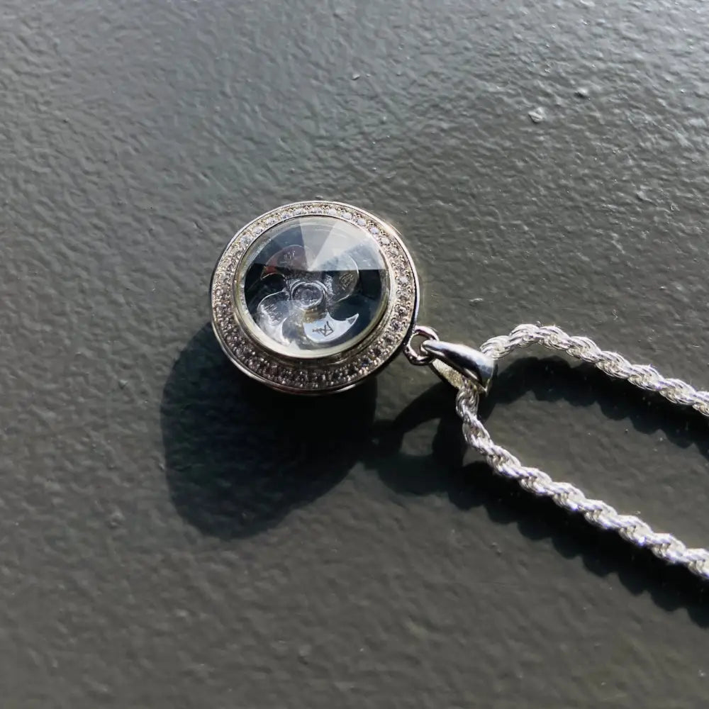 Silver flooded spinning rope chain necklace with clear gemstone pendant, elegant jewelry piece