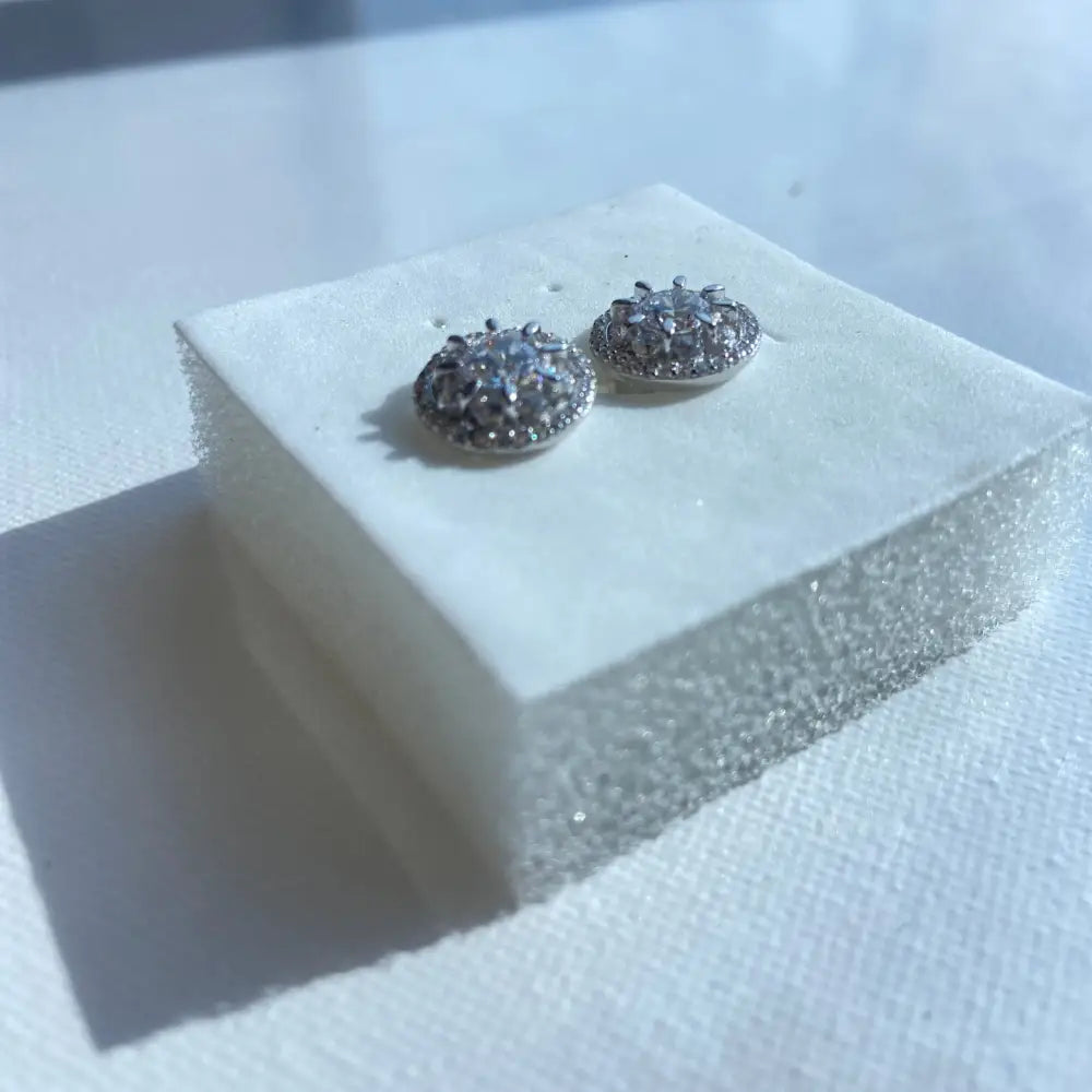 Silver ice wheel earrings with light blue gemstones and clear stones in white gold silver finish